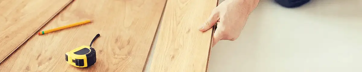 A professional installing wood flooring in Mobile, AL