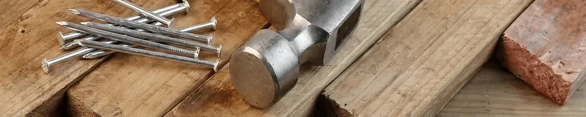 Hammer and nails on hardwood flooring boards in Mobile, AL