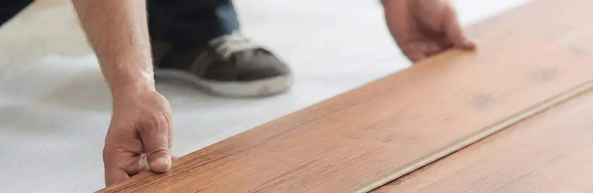 A professional installing laminate flooring in Mobile, AL