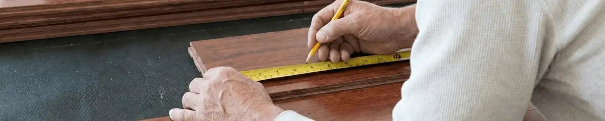 A professional installing wood flooring in Mobile, AL